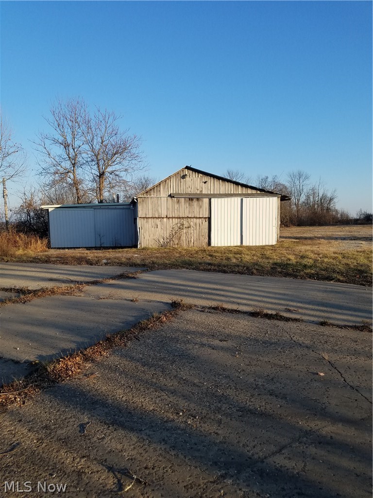 44112 Archers Ridge Road Caldwell, OH 43724 - Photo 26 of 30 workshop with 2 sliding doors and gravel floor. attached office with 220 electric, wood burner and concrete floor. Water at road.