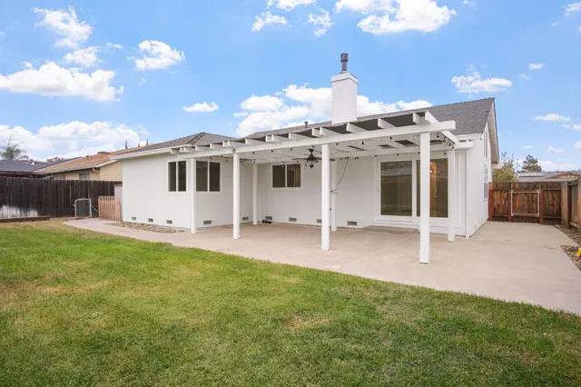 a swimming pool with yard and outdoor seating