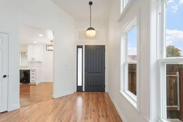 a view of a room with wooden floor and windows