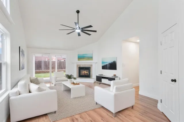 a living room with furniture fireplace and flat screen tv