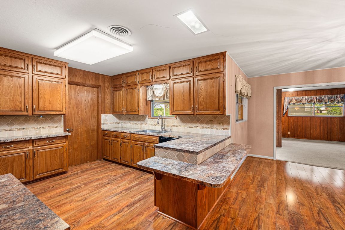 1800 Barbara Street Austin, TX 78757 - Photo 14 of 37 a kitchen with granite countertop a stove and cabinets