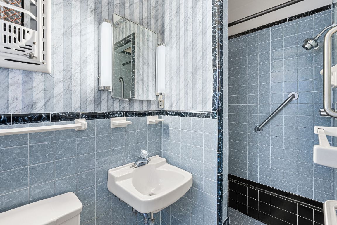 1800 Barbara Street Austin, TX 78757 - Photo 21 of 37 a bathroom with a sink a mirror and shower