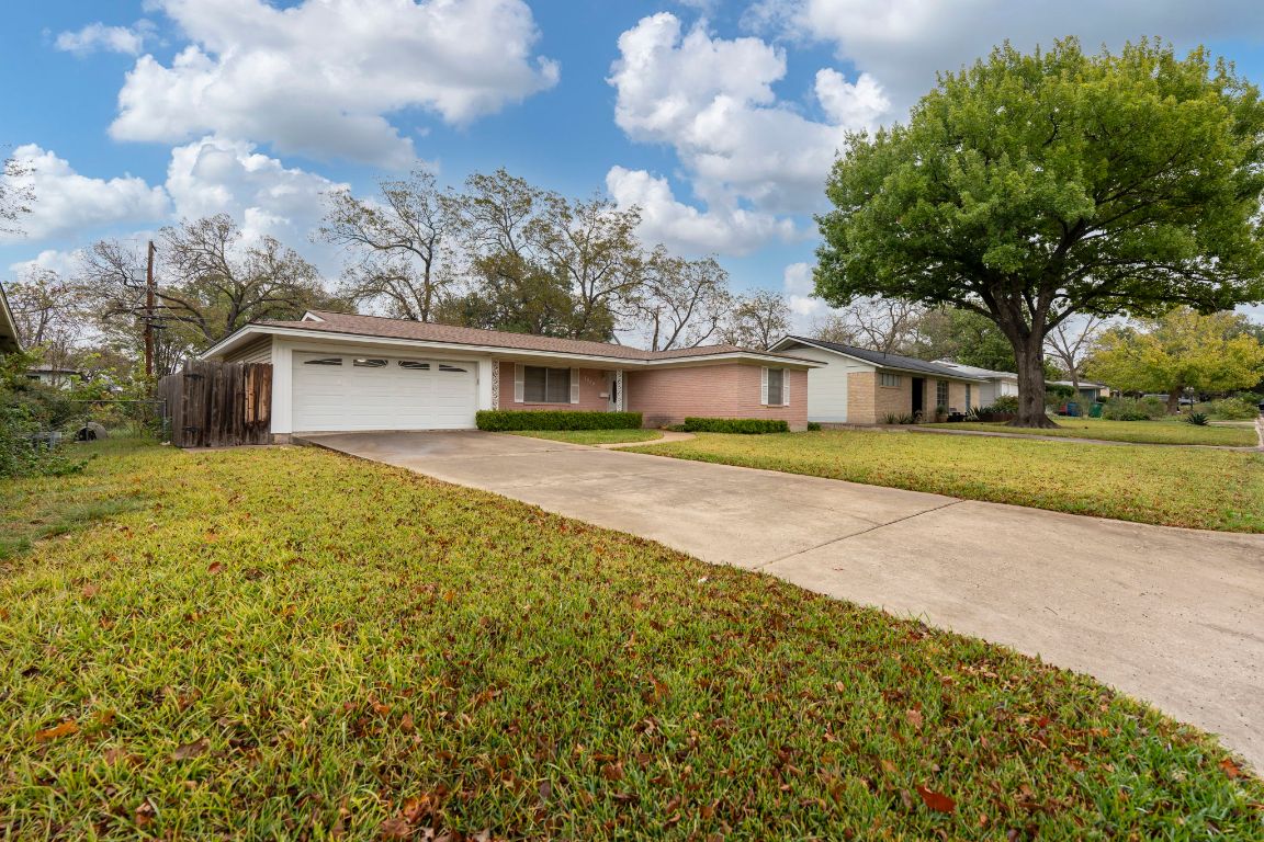 1800 Barbara Street Austin, TX 78757 - Photo 3 of 37 a view of a house with a big yard and large trees