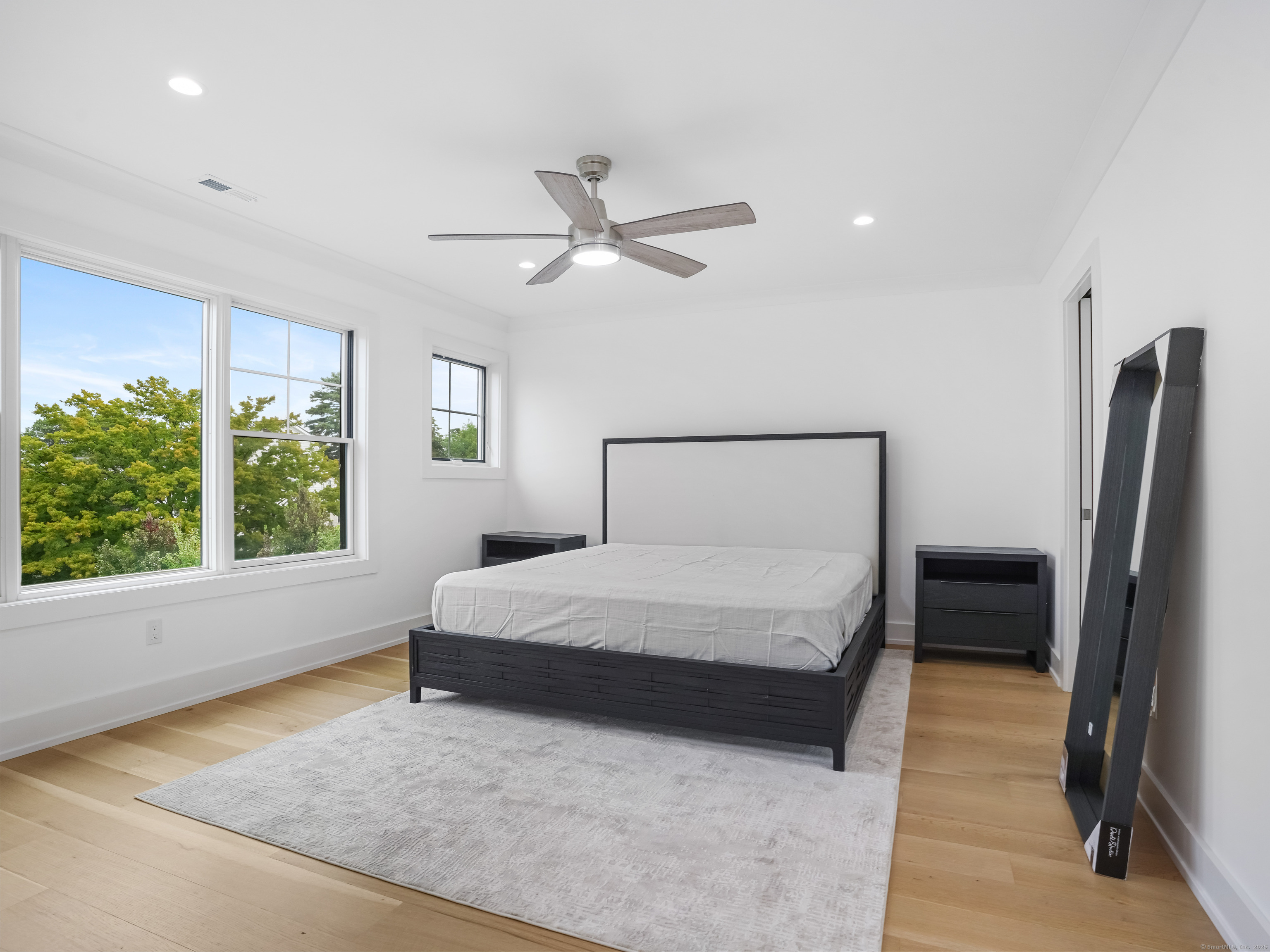 345 Reef Road, Unit C9 Fairfield, CT 06824 - Photo 21 of 39 a bedroom with a large bed and a large window