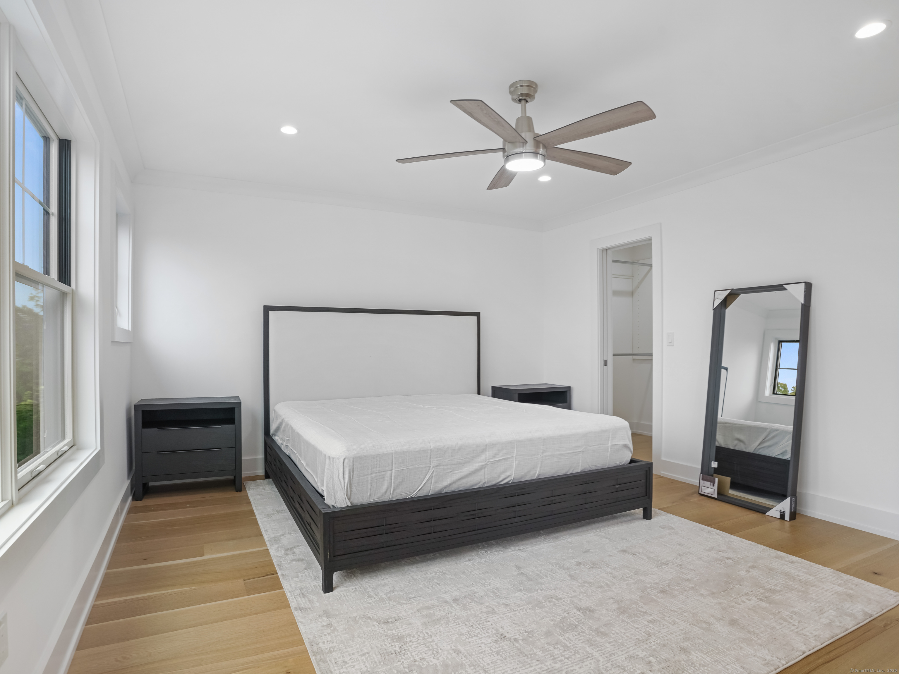 345 Reef Road, Unit C9 Fairfield, CT 06824 - Photo 37 of 39 a bedroom with a bed and a mirror