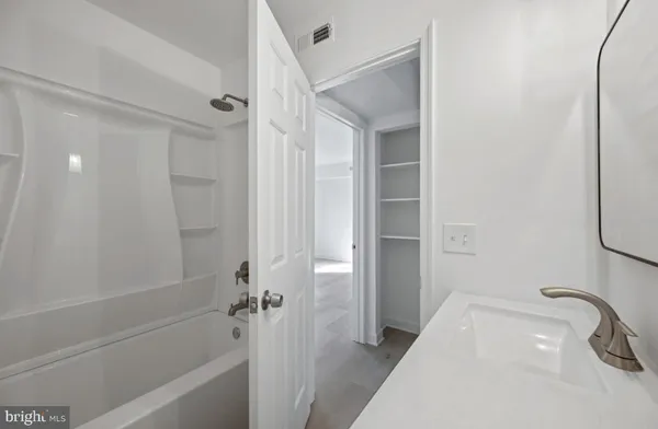 a bathroom with a tub and a shower