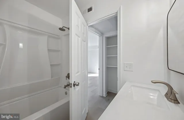 a bathroom with a tub and a shower