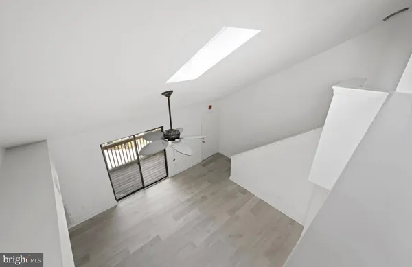 a view of a hallway with furniture