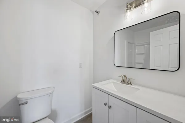 a bathroom with a sink a toilet and mirror