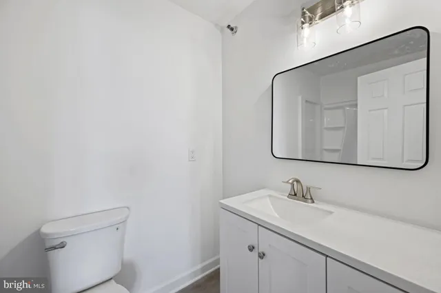 a bathroom with a sink a toilet and mirror