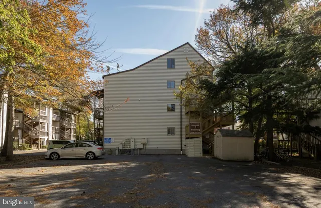 a view of a white house in a city street
