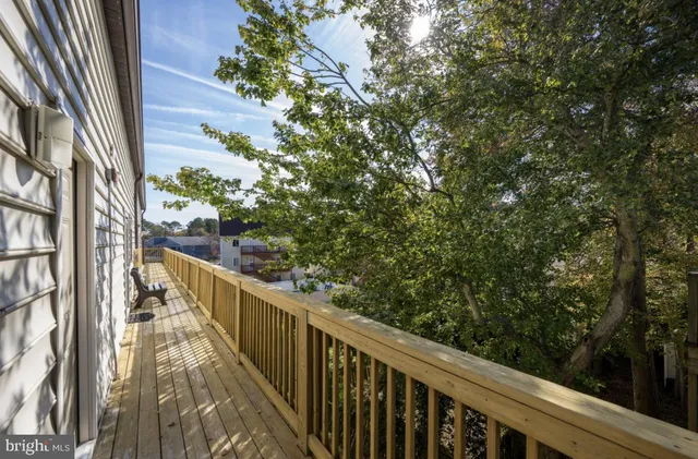 a view of a balcony with wooden stairs