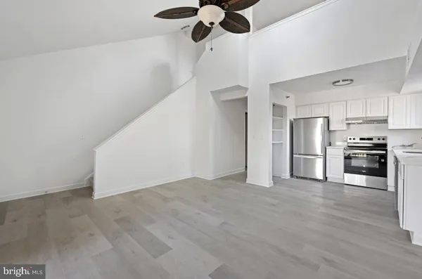 a view of a kitchen with a stove cabinets and ceiling fan