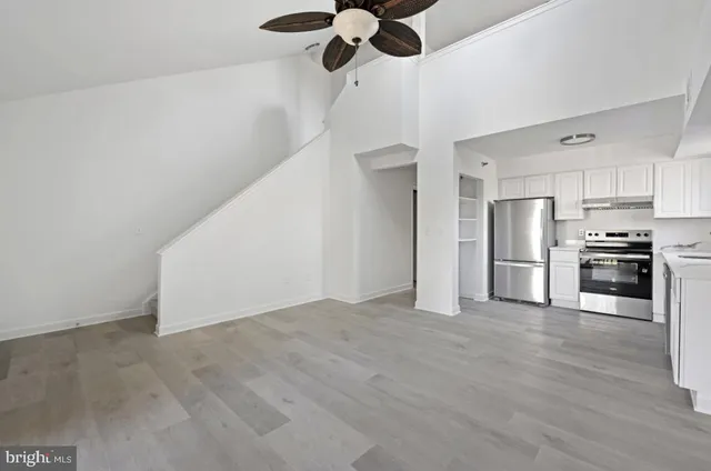 a view of a kitchen with a stove cabinets and ceiling fan
