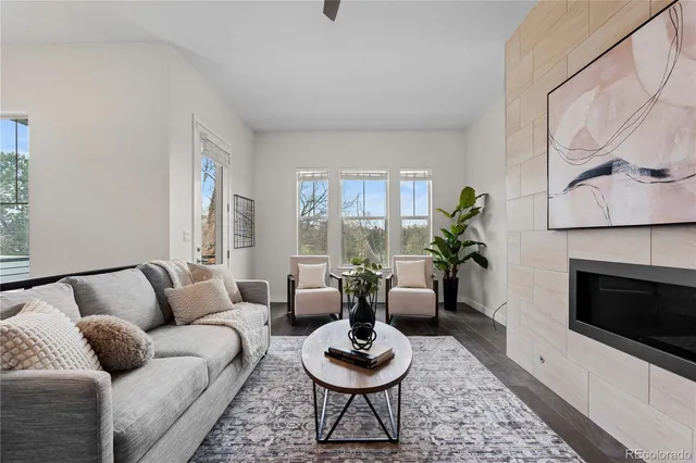 a living room with furniture and a fireplace