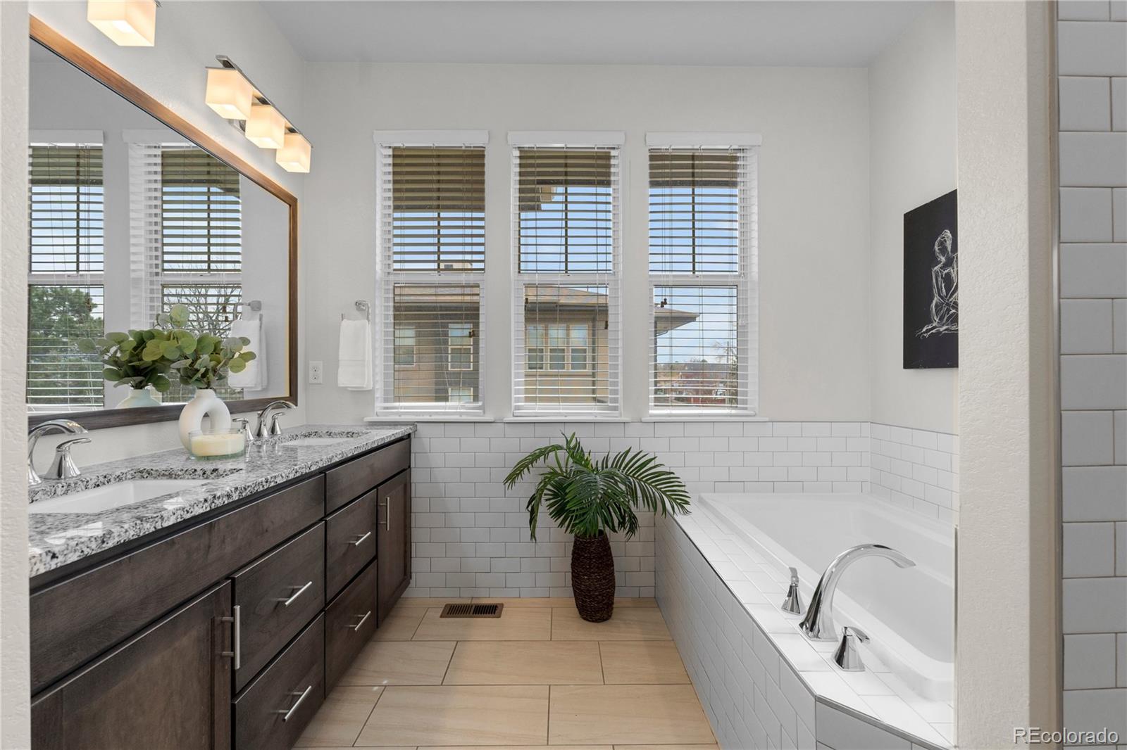 188 South Locust Street Denver, CO 80224 - Photo 15 of 29 a bathroom with a granite countertop tub a sink and a window
