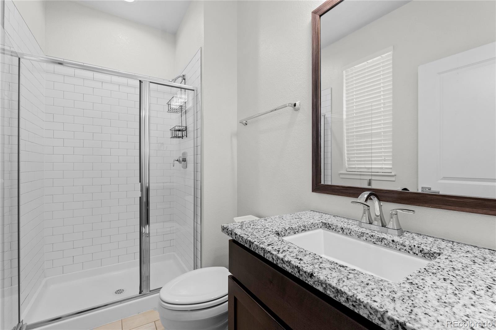 188 South Locust Street Denver, CO 80224 - Photo 20 of 29 a bathroom with a granite countertop sink toilet and shower