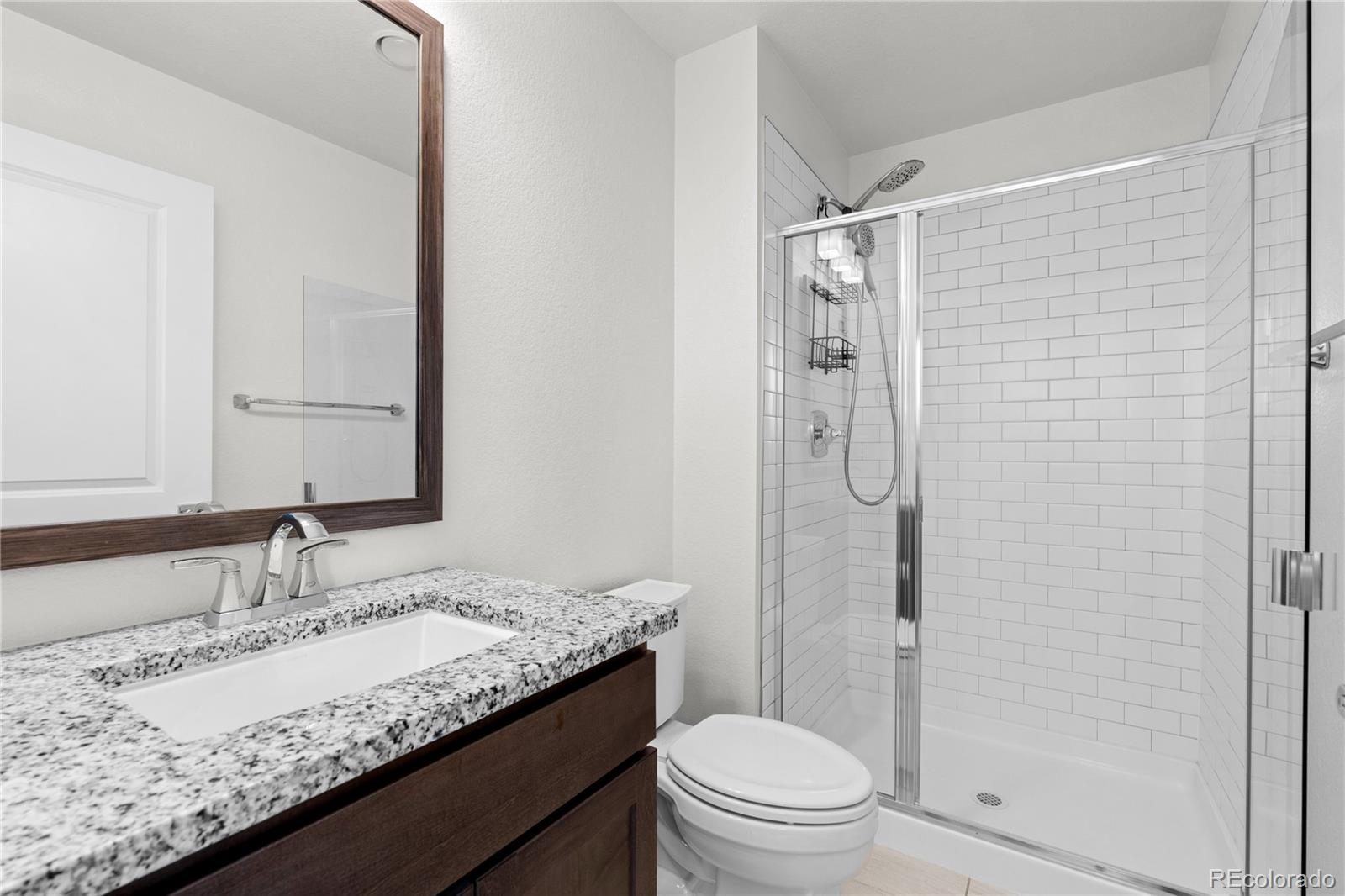 188 South Locust Street Denver, CO 80224 - Photo 24 of 29 a bathroom with a granite countertop sink toilet and shower