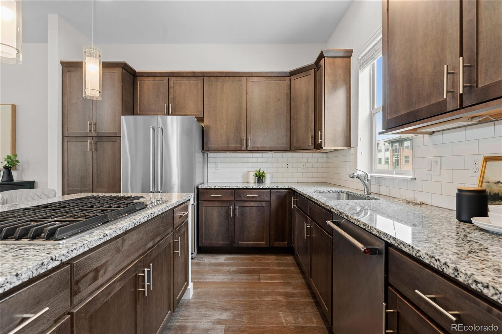 188 South Locust Street Denver, CO 80224 - Photo 6 of 29 a kitchen with granite countertop a sink stove and refrigerator