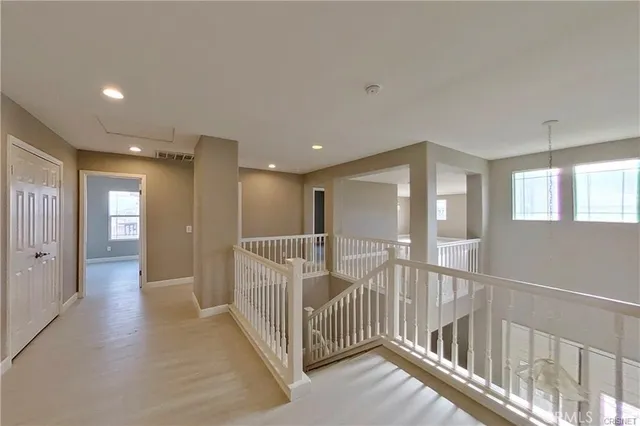 a view of a hallway with windows
