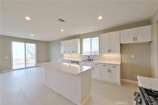 a kitchen with sink and cabinets