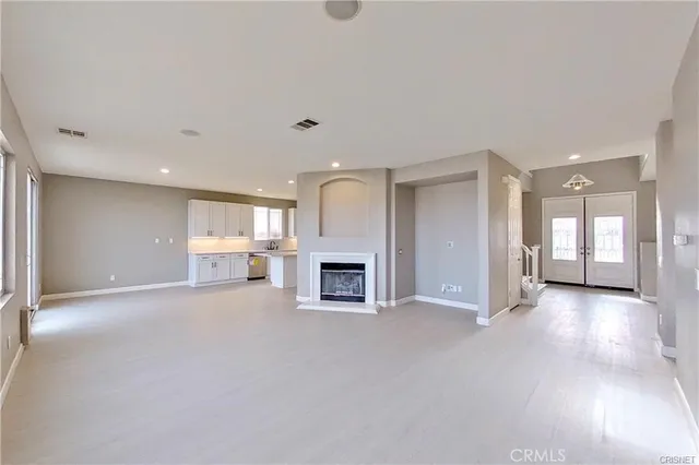 a view of a livingroom with a fireplace a window and a fireplace