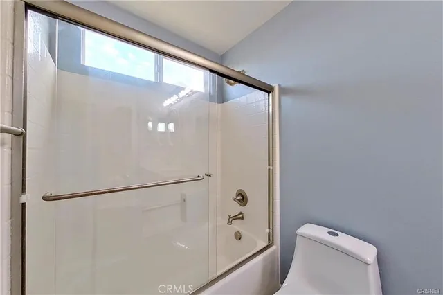 a bathroom with a toilet and a shower