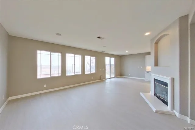 a view of empty room with a fireplace