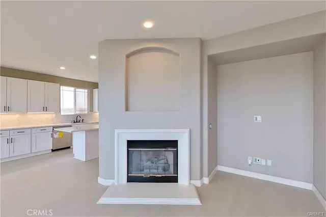 a view of a kitchen with a sink and a fireplace