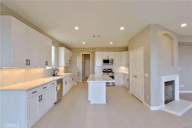 a large kitchen with stainless steel appliances lots of counter top space