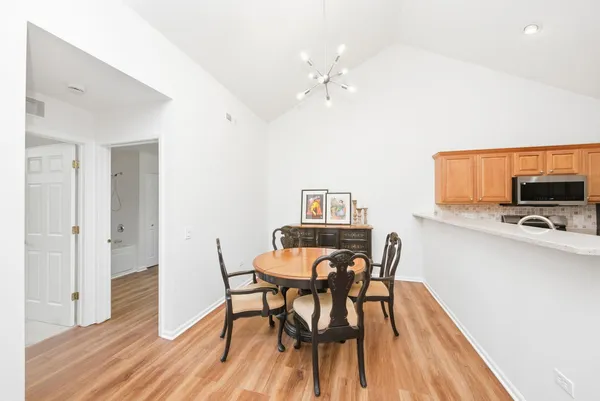 a view of a dining room with furniture and wooden floor
