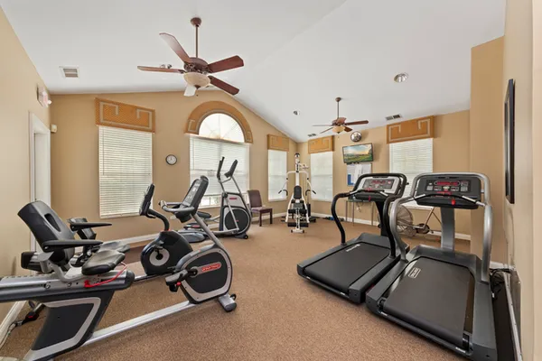 a room with gym equipment and large mirror
