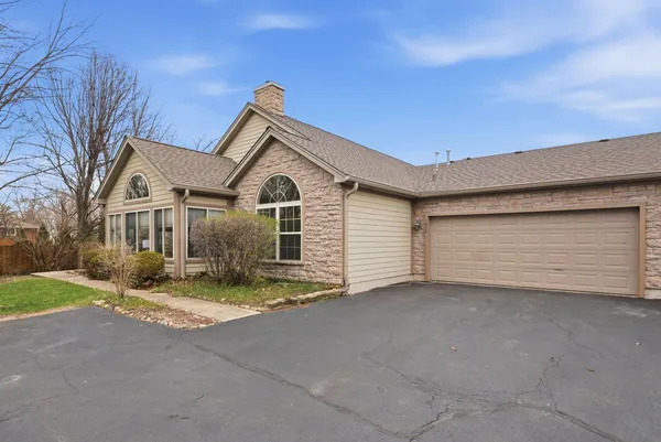 a view of house with yard and garage