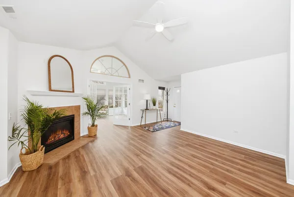 a view of empty room with fireplace and wooden floor