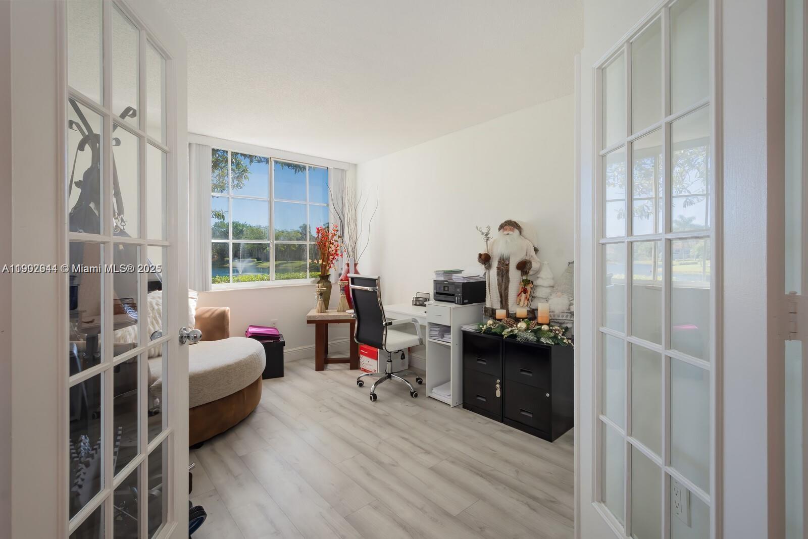 12160 St Andrews Place, Unit 108 Miramar, FL 33025 - Photo 11 of 16 a bedroom with furniture and a window