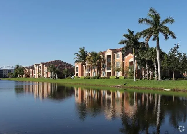 a view of residential house with outdoor space and lake
