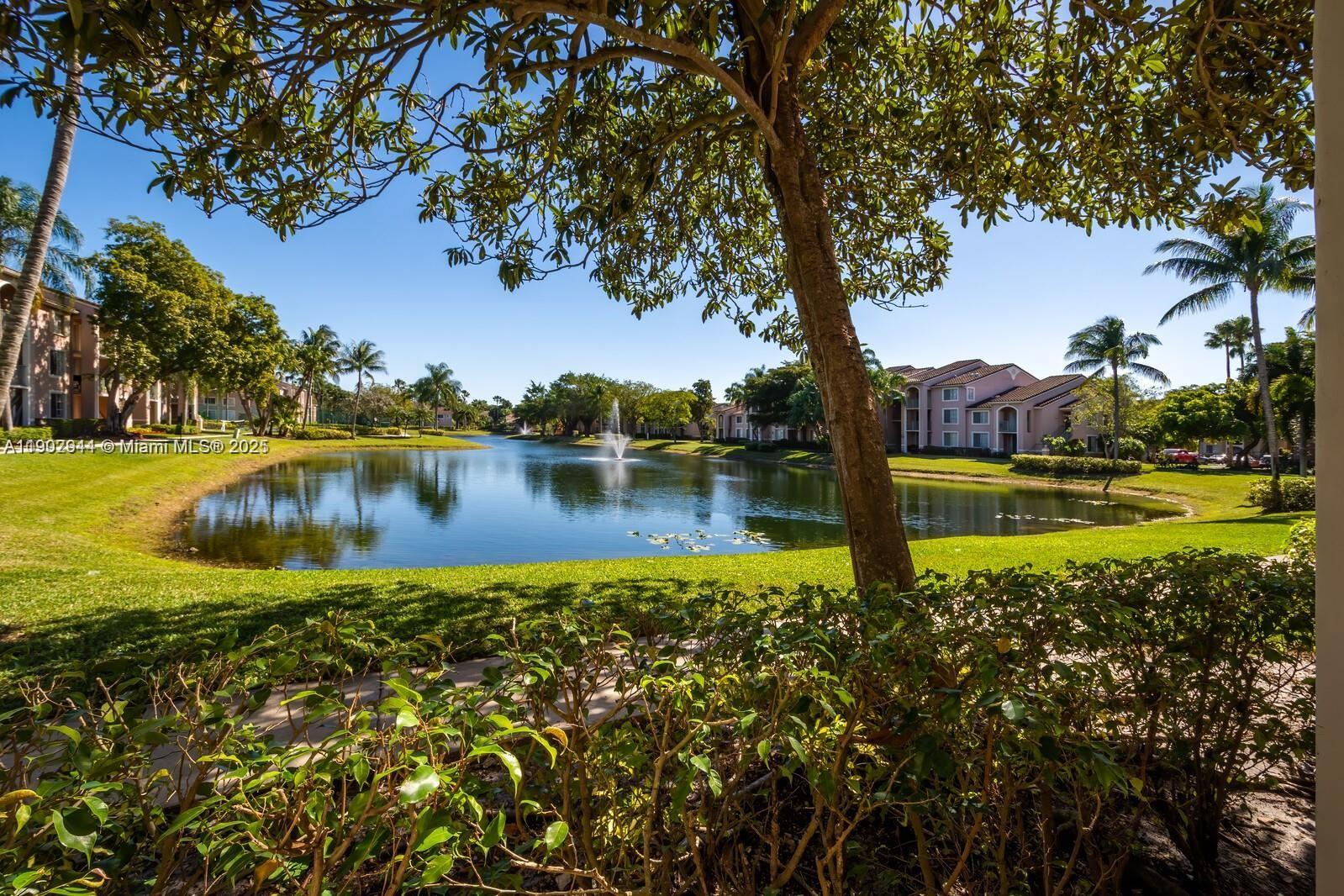 12160 St Andrews Place, Unit 108 Miramar, FL 33025 - Photo 16 of 16 a view of a lake with houses in the back