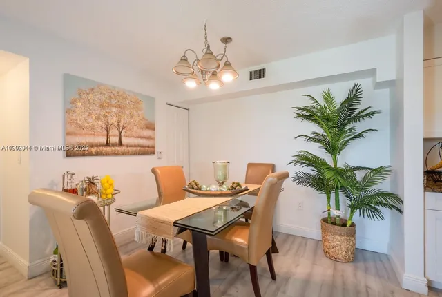 a view of a dining room with furniture wooden floor and chandelier