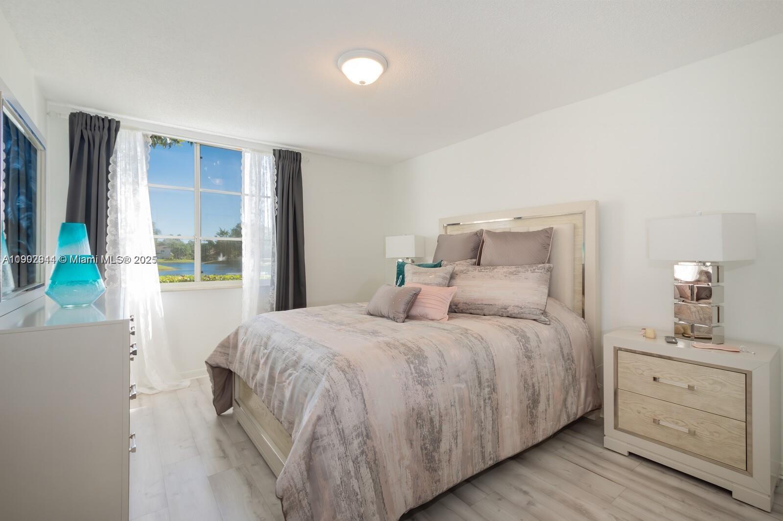 12160 St Andrews Place, Unit 108 Miramar, FL 33025 - Photo 7 of 16 a bedroom with a bed and a window