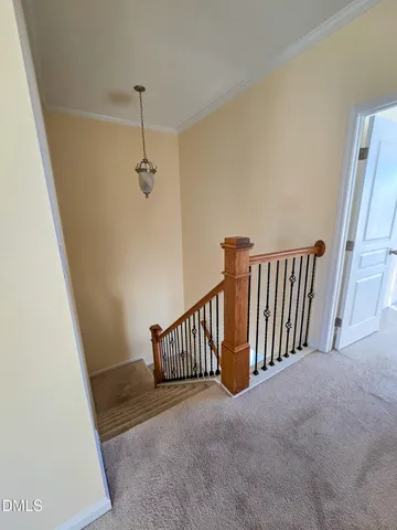 a view of a hallway with stairs