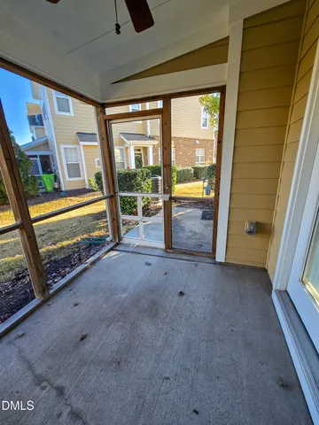 a view of an empty room with a fireplace and a large window