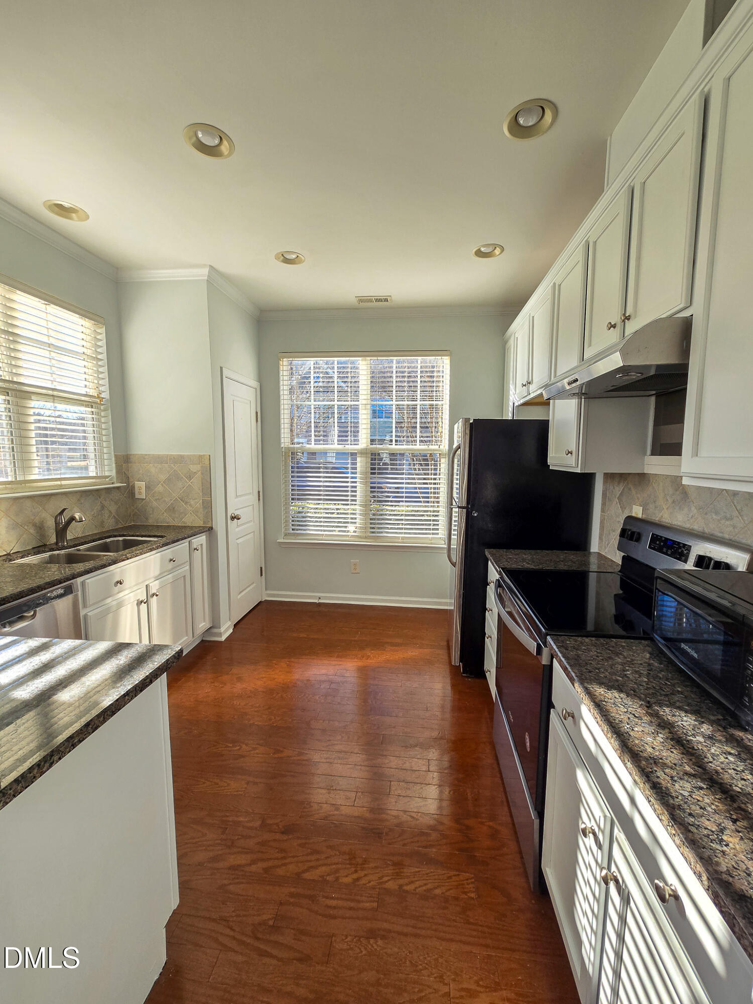 10104 Raven Tree Drive Raleigh, NC 27617 - Photo 7 of 33 a kitchen with stainless steel appliances granite countertop a stove and a refrigerator