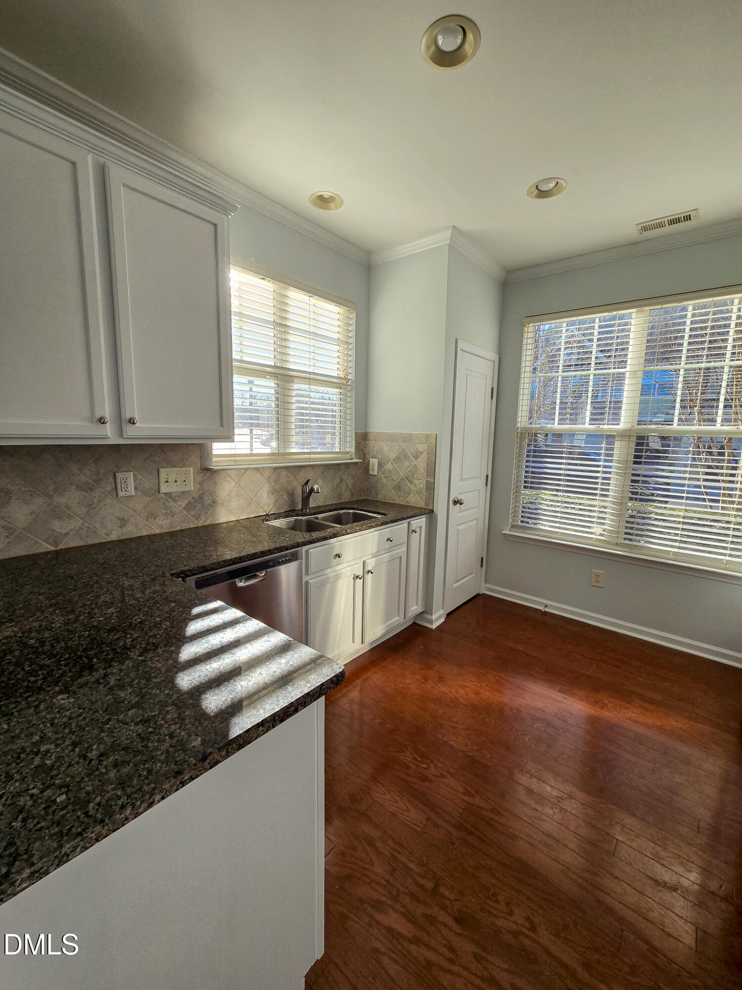 10104 Raven Tree Drive Raleigh, NC 27617 - Photo 8 of 33 a kitchen with granite countertop a sink and a stove top oven