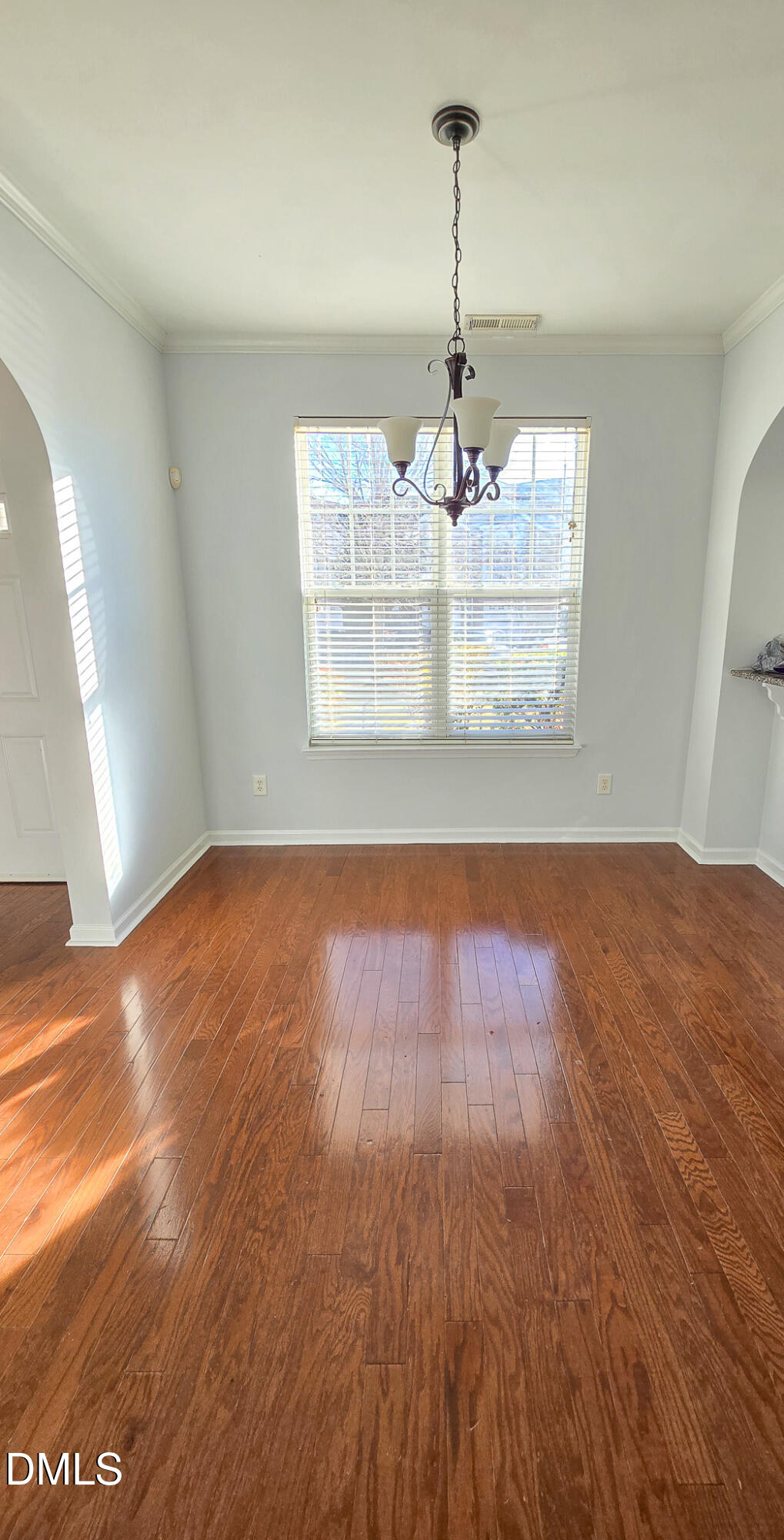 10104 Raven Tree Drive Raleigh, NC 27617 - Photo 10 of 33 a view of a room with wooden floor large window and wooden floor