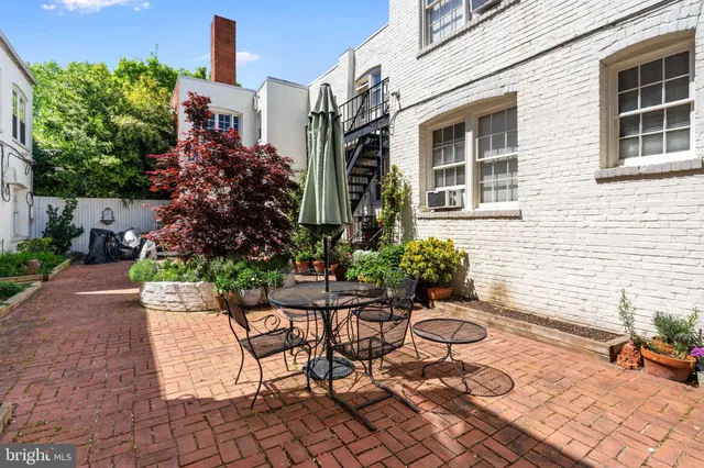 a view of a patio with table and chairs and potted plants