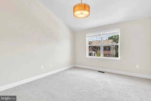 an empty room with windows and painted walls