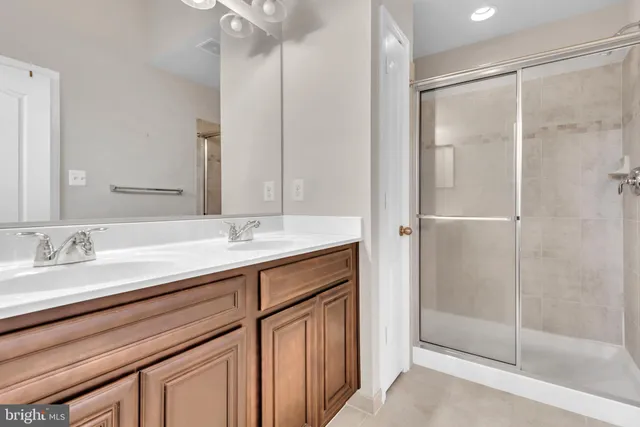 a bathroom with a double vanity sink and a mirror