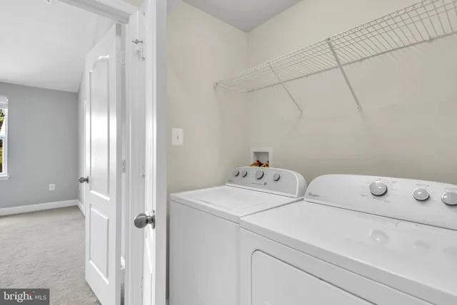 a view of a room with stairs and a ceiling fan