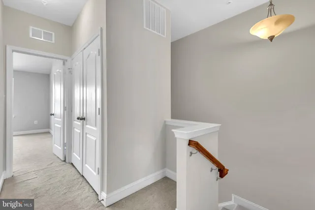 a view of a house with a balcony and wooden floor