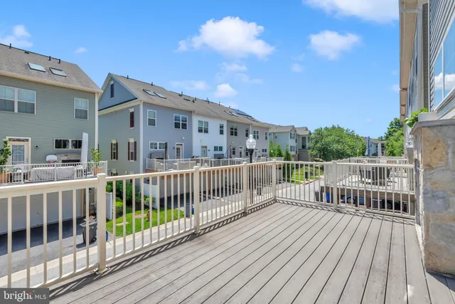 a front view of a house with a big yard and potted plants